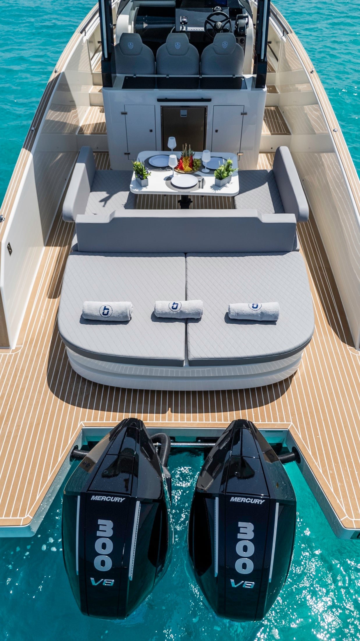 Kumbra 34 aft sunbed, cockpit and twin outboard engines from above