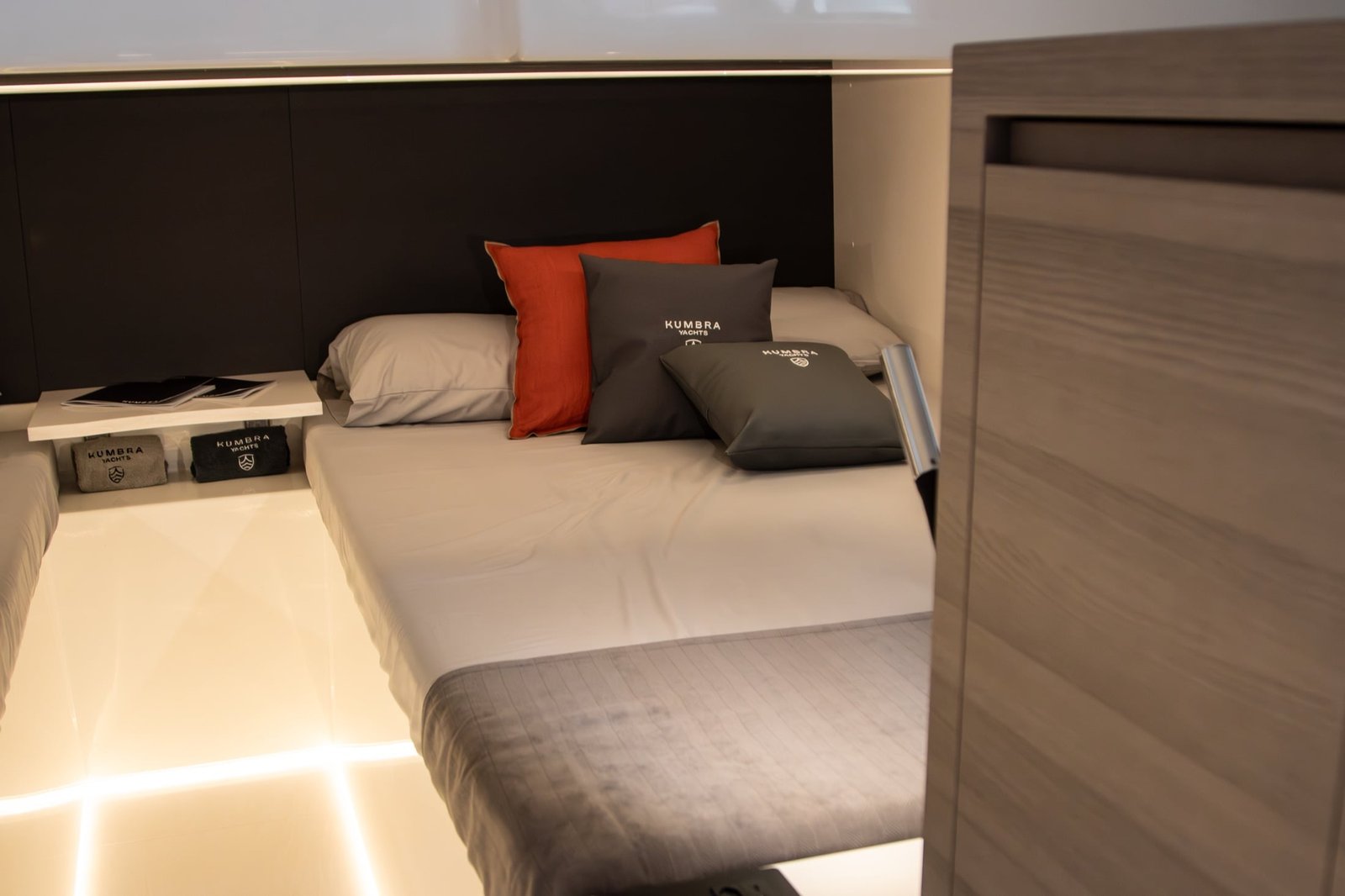 Kumbra 43 aft guest cabin with two beds and branded cushions