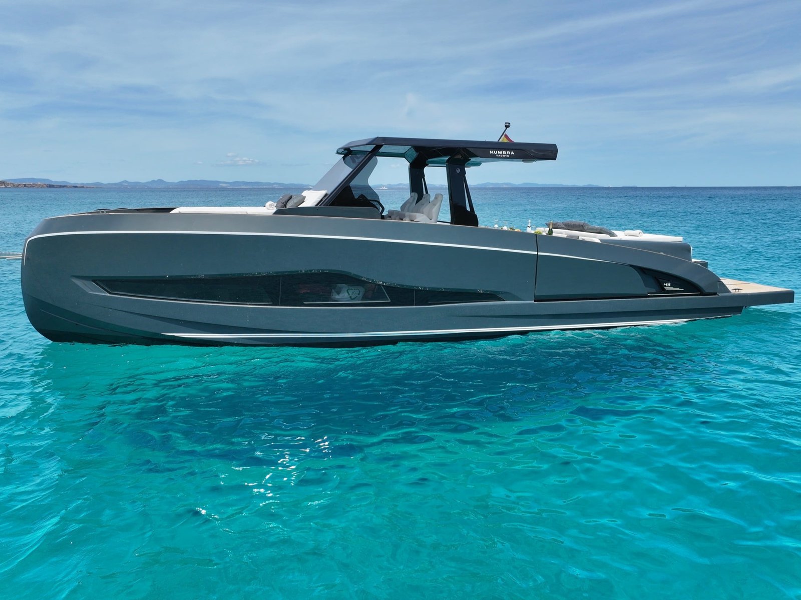Full side profile of the grey Kumbra 43 on turquoise water