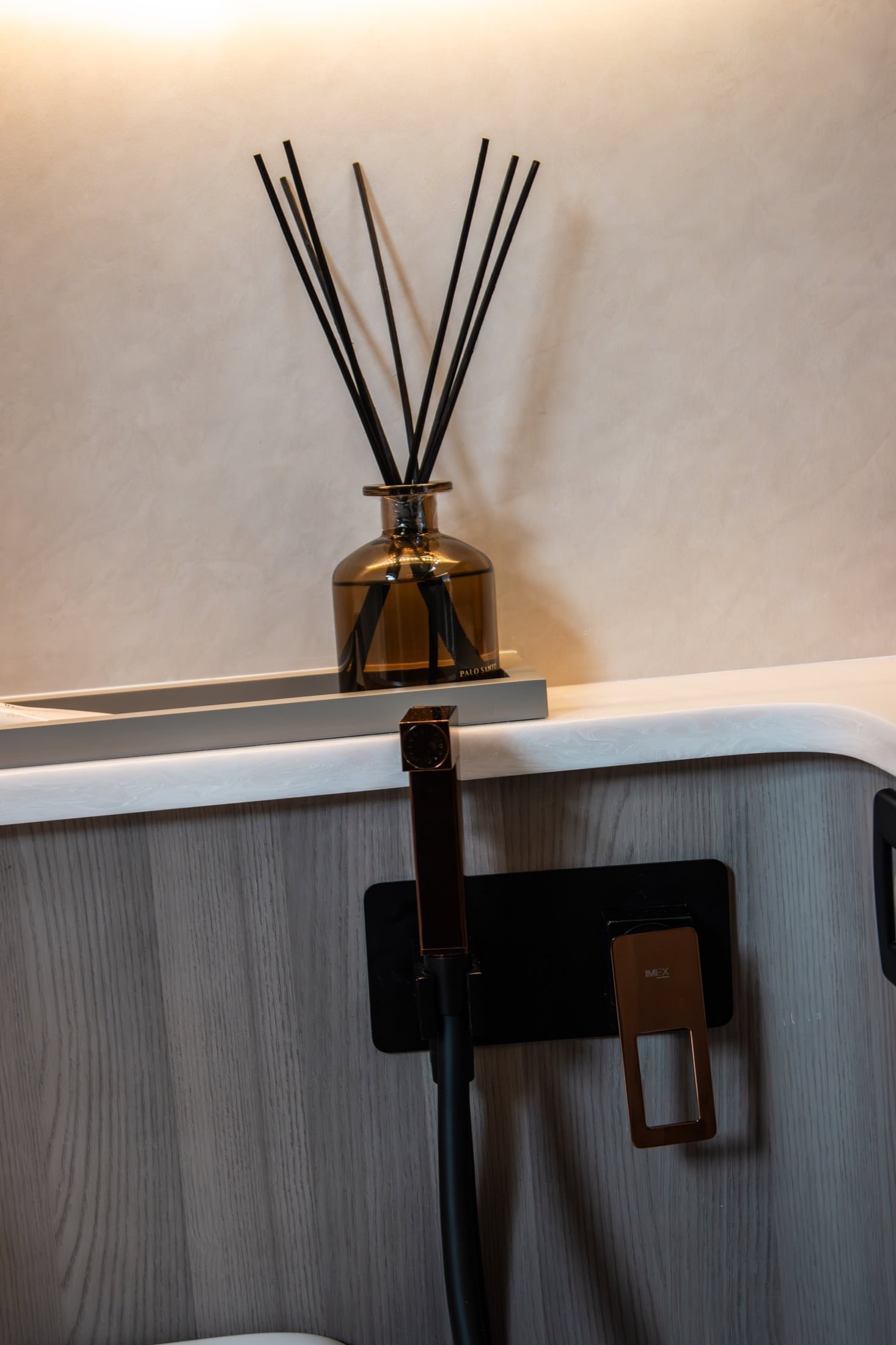 Kumbra 43 bathroom vanity detail with diffuser and dark faucet